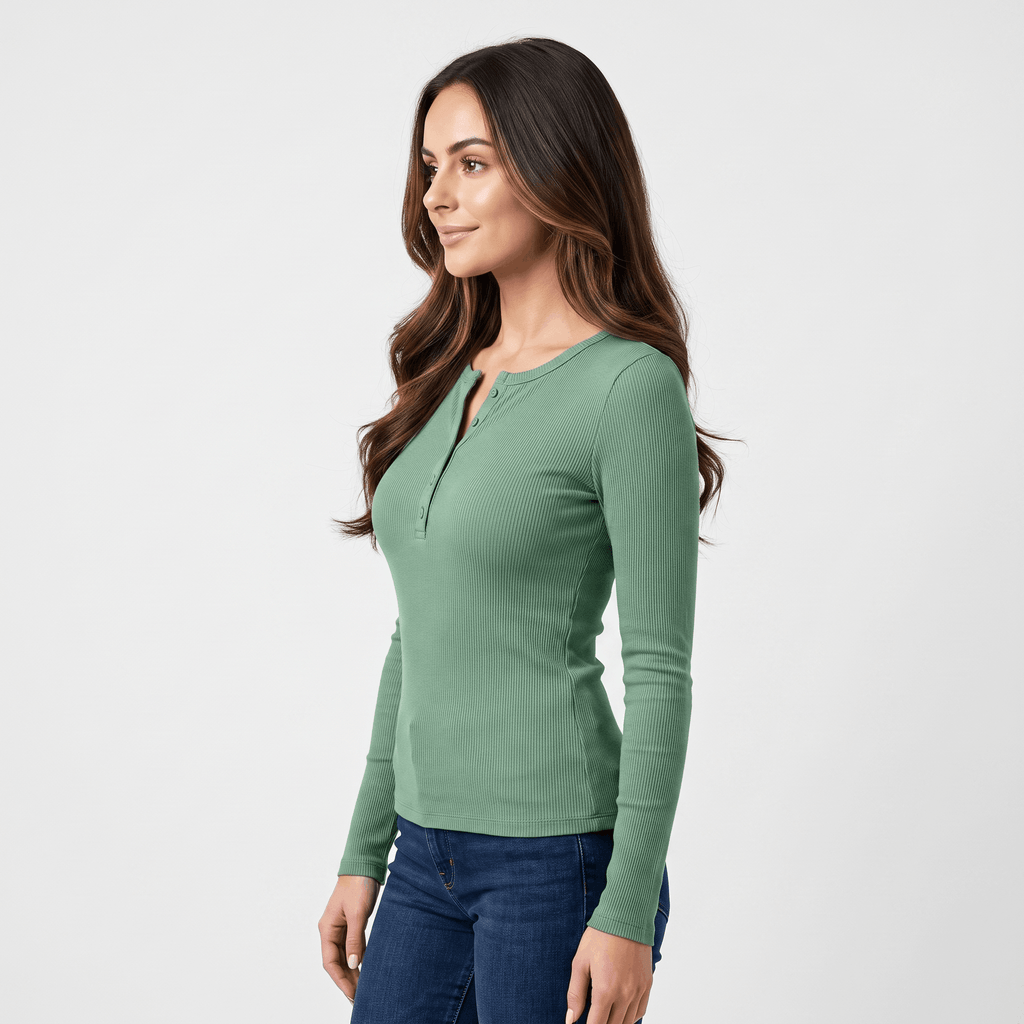 Side view of a woman wearing a green ribbed henley top with a fitted silhouette, long sleeves, and buttoned neckline.