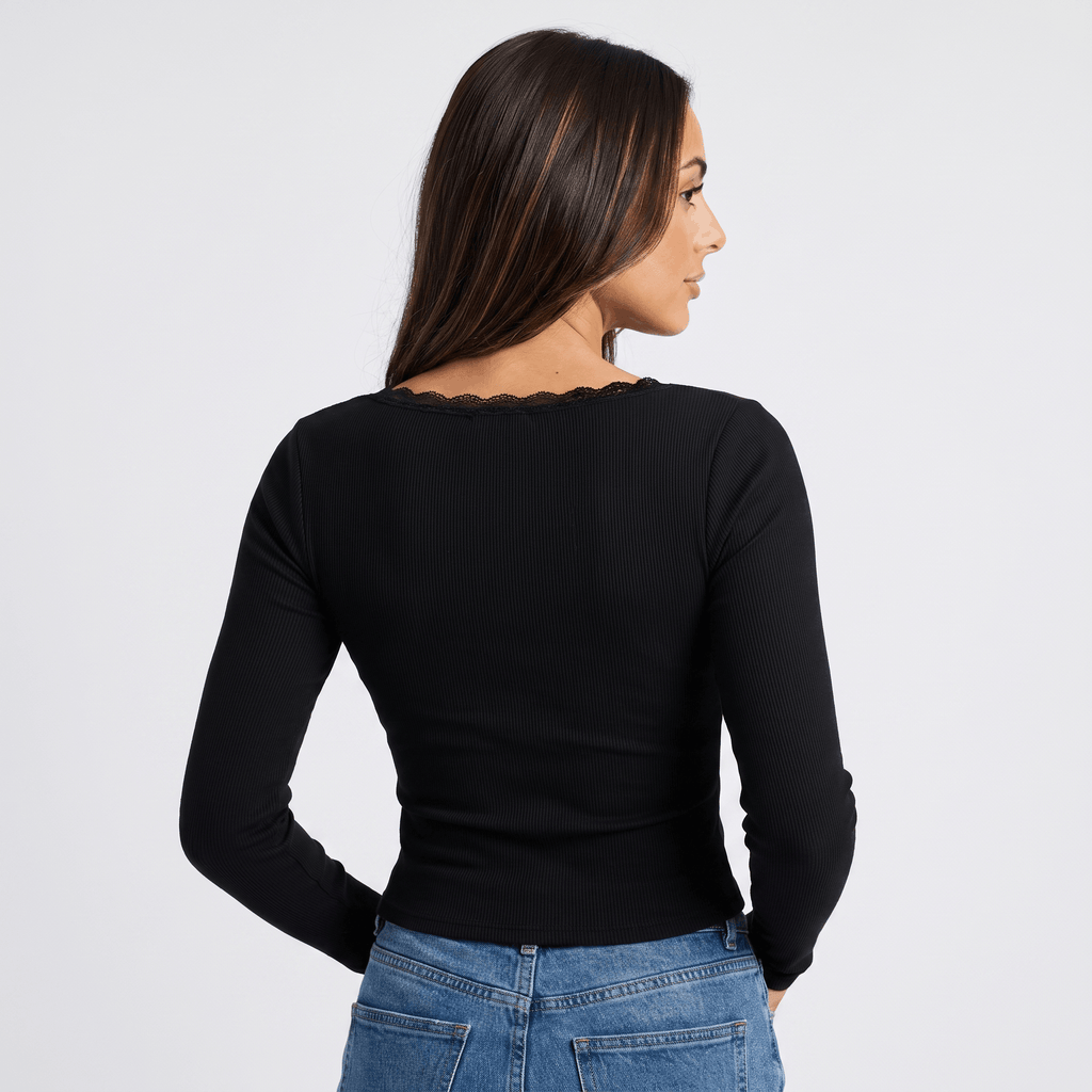 Back view of a woman wearing a black fitted ribbed long sleeve top with a simple minimalist design.