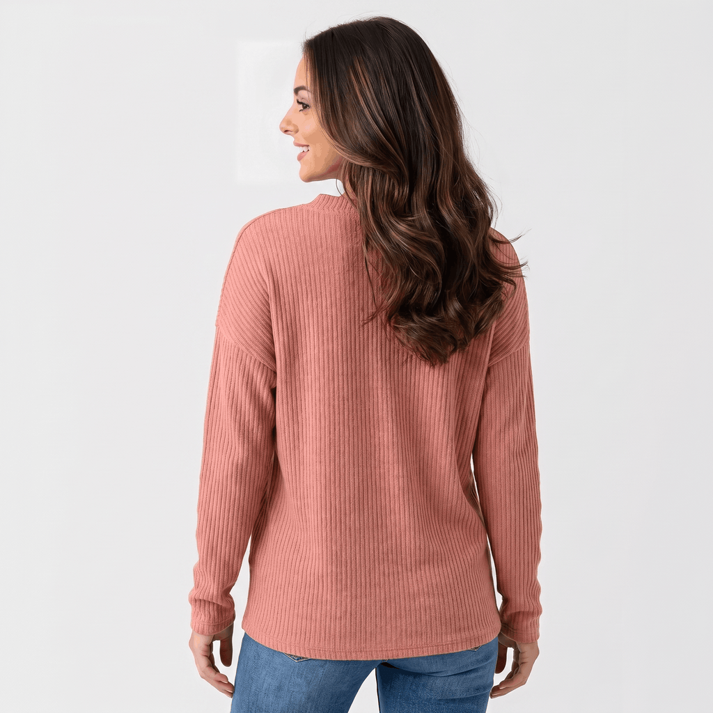Front view of a woman wearing a dusty rose ribbed henley sweater with a button neckline and long sleeves.
