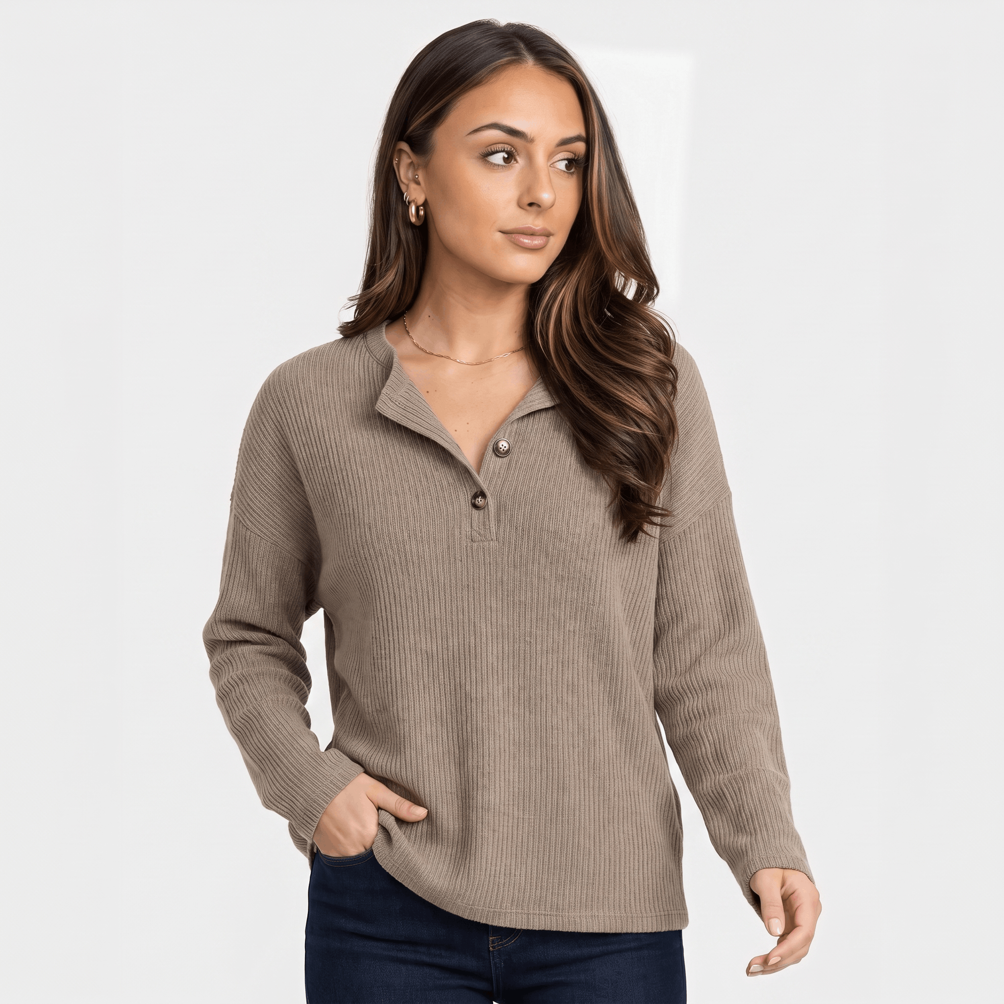 Woman wearing a taupe ribbed henley sweater with a button neckline, long sleeves, and relaxed fitted silhouette.