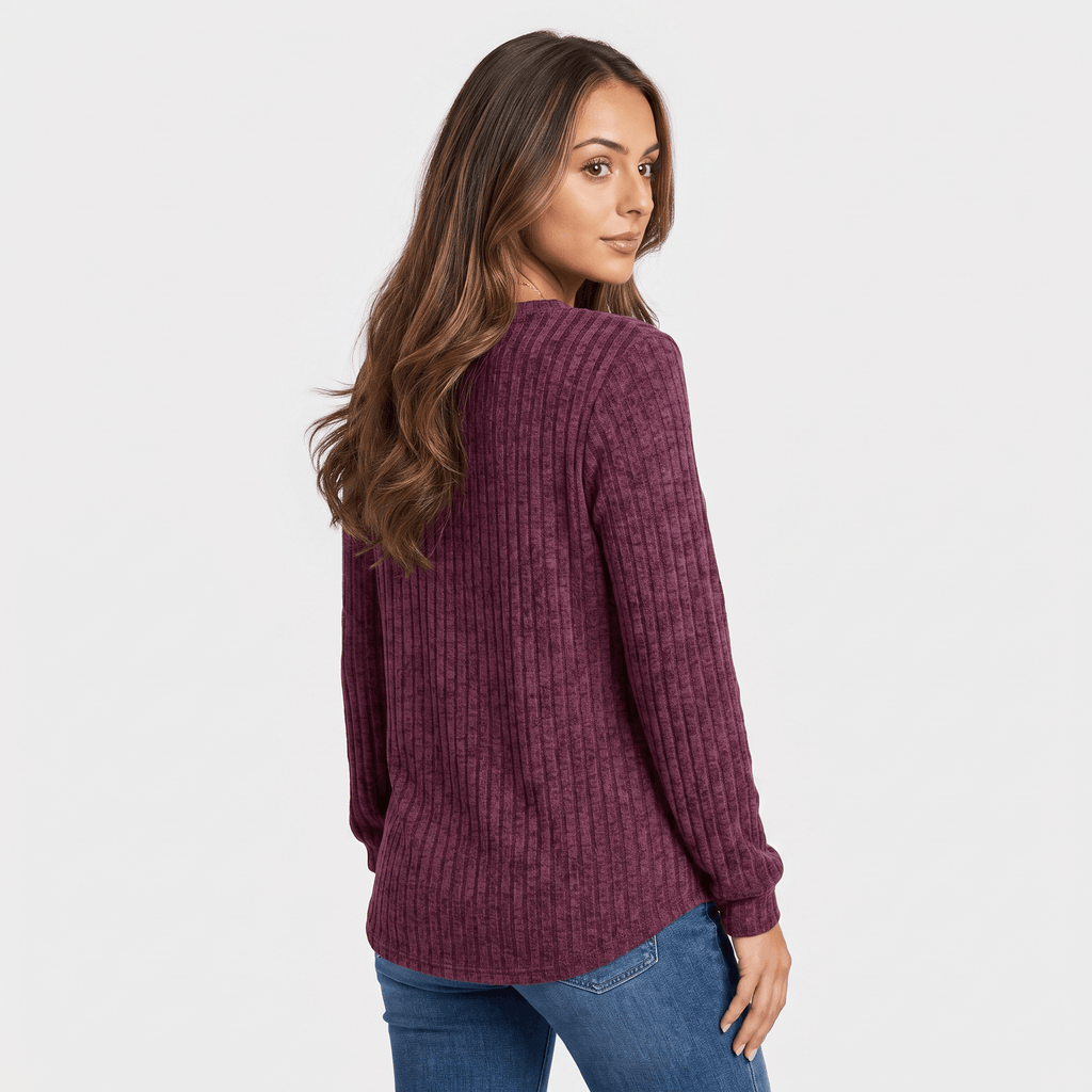 Back view of a woman wearing a burgundy textured henley sweater with a relaxed fit and long sleeves.