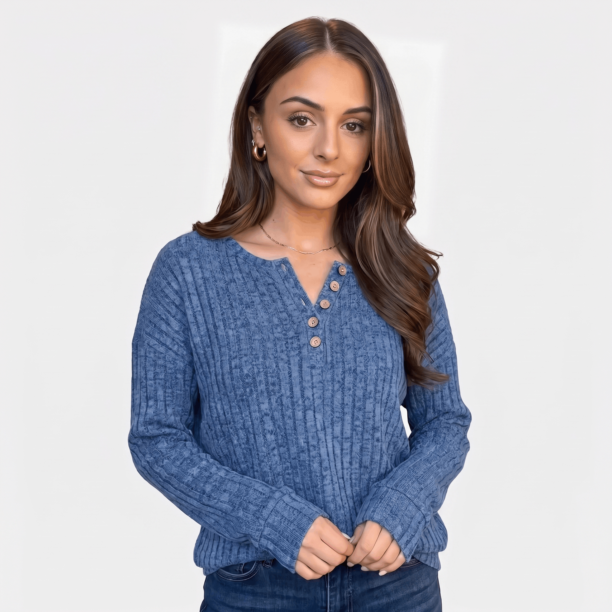 Woman wearing a blue textured henley sweater with a button neckline and long sleeves.