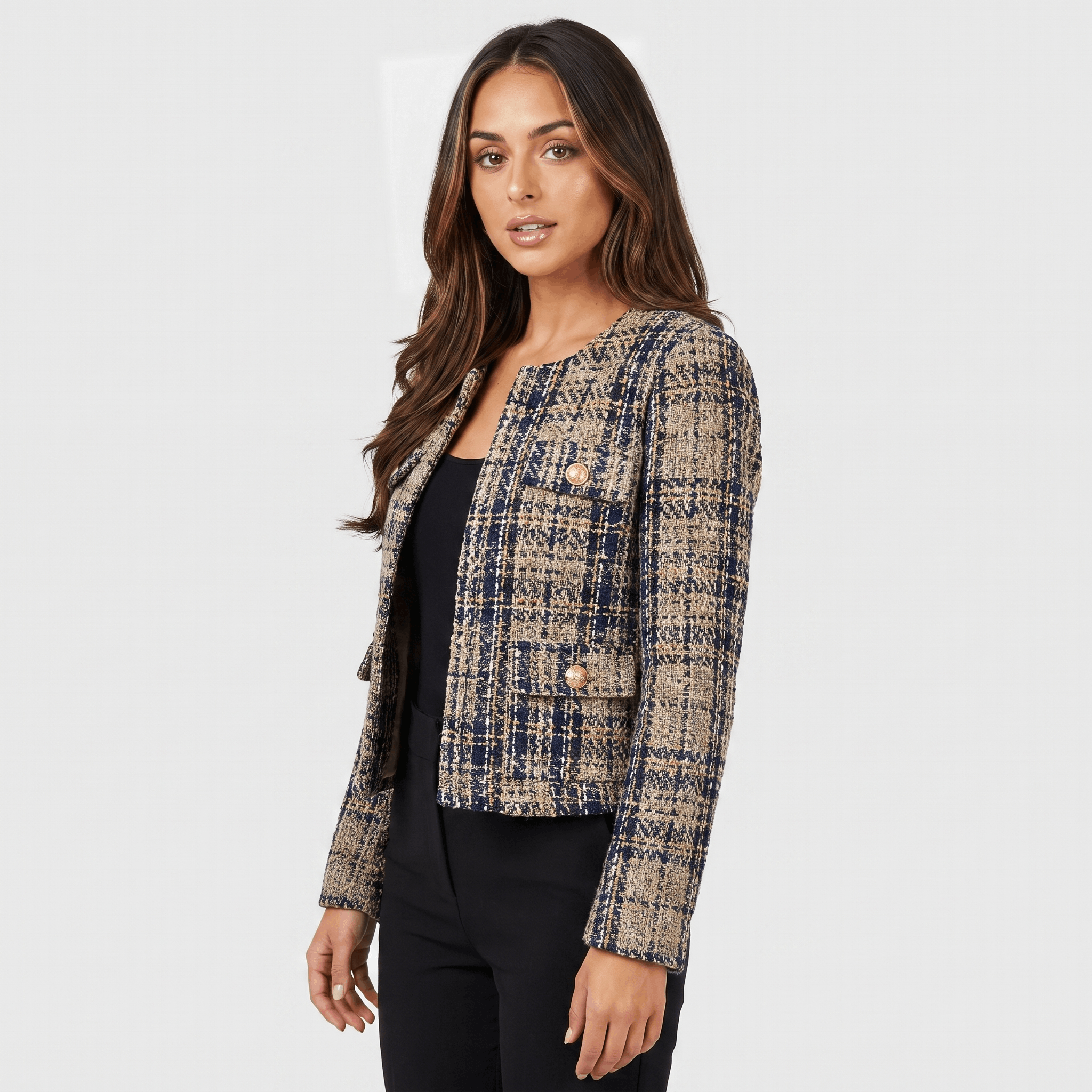 Side view of a woman wearing a blue and beige plaid tweed jacket with gold-tone buttons, long sleeves, and tailored silhouette.