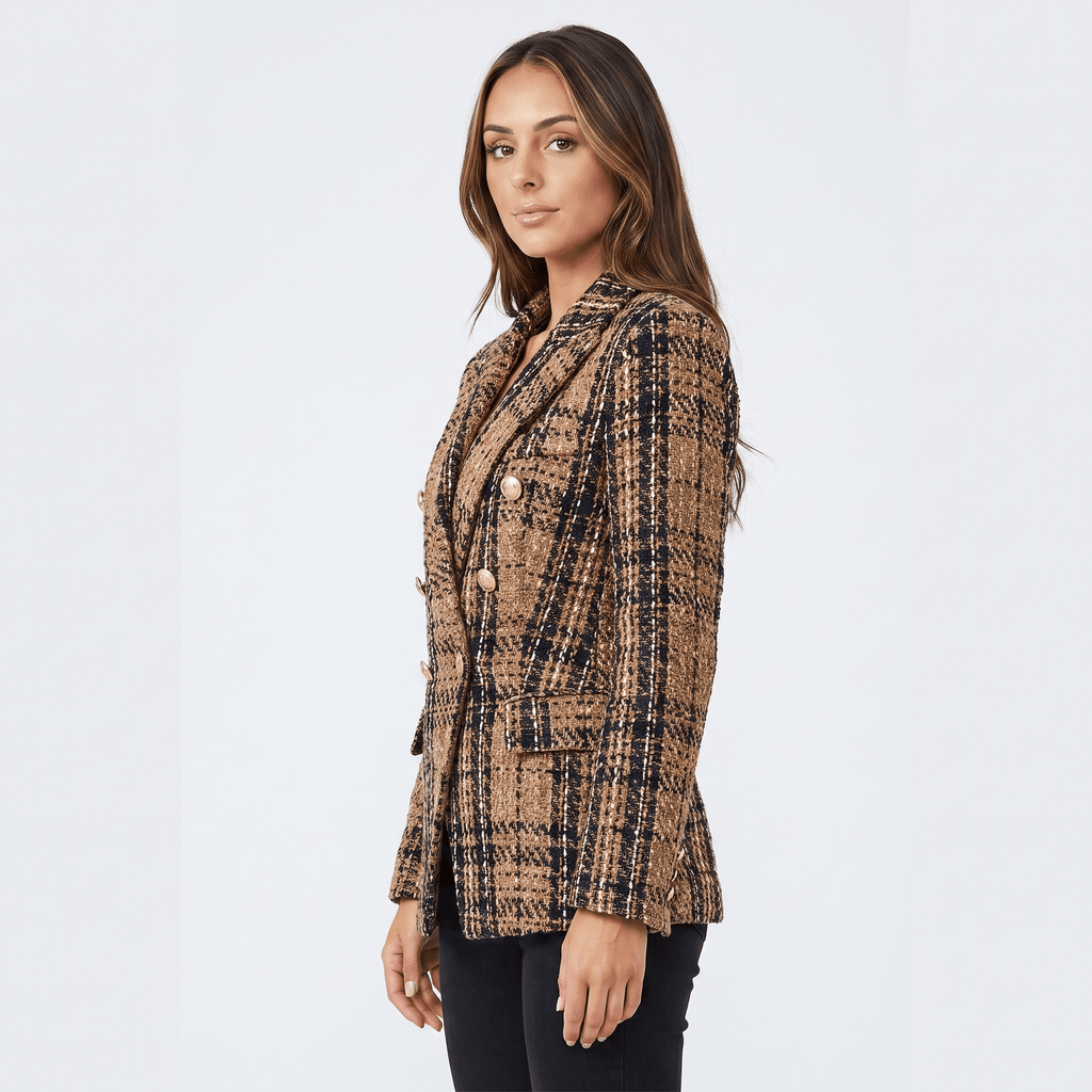 Side view of a woman wearing a brown plaid tweed blazer with a double-breasted front, notched lapels, and tailored silhouette.