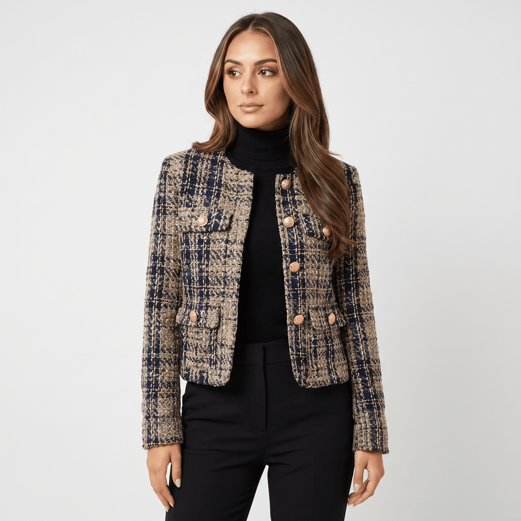 Woman wearing a blue and beige plaid tweed jacket with gold-tone buttons and black trousers in a front-facing studio view.