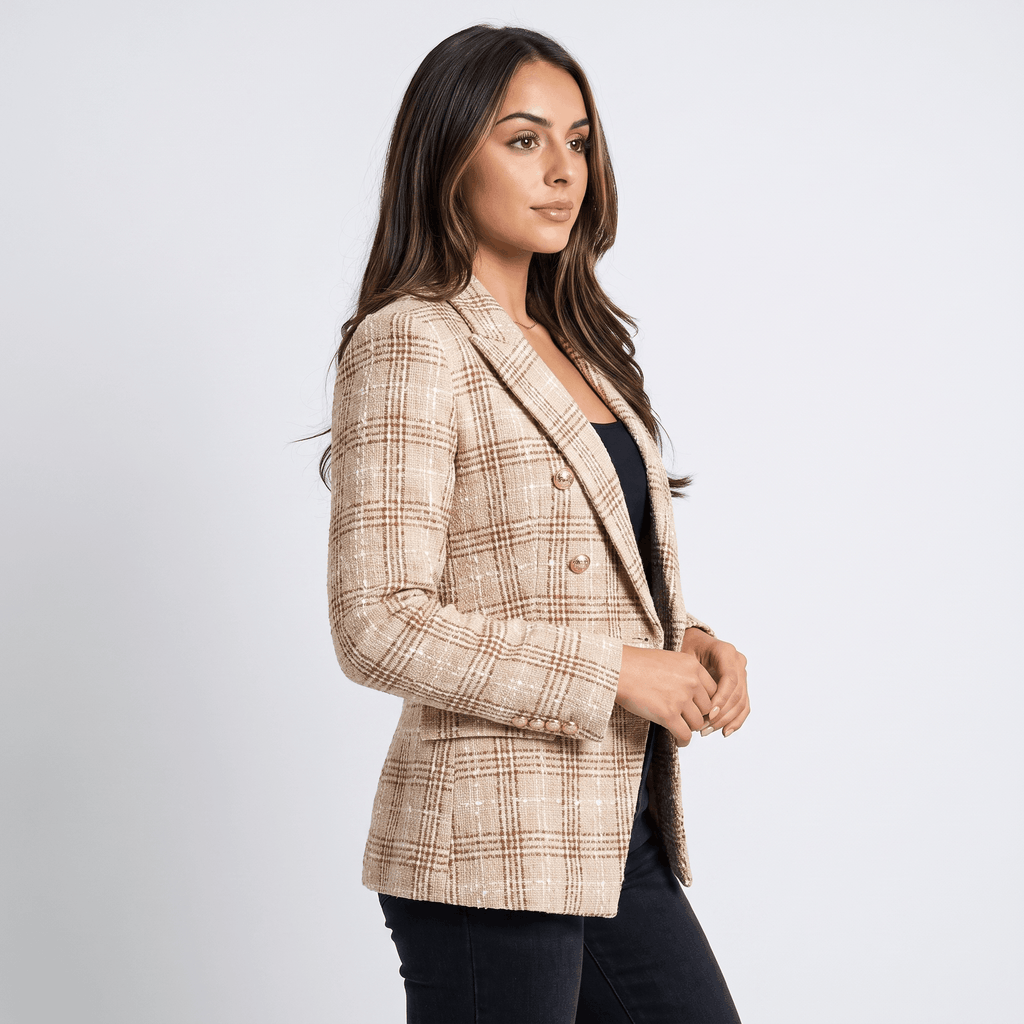 Back view of a woman wearing a beige plaid tweed blazer with a tailored silhouette and long sleeves.