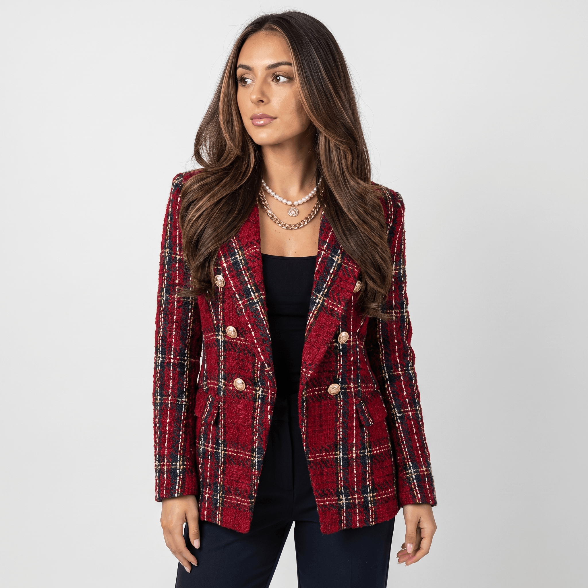 Side view of a woman wearing a red plaid tweed blazer with gold-tone buttons, notched lapels, and tailored silhouette.