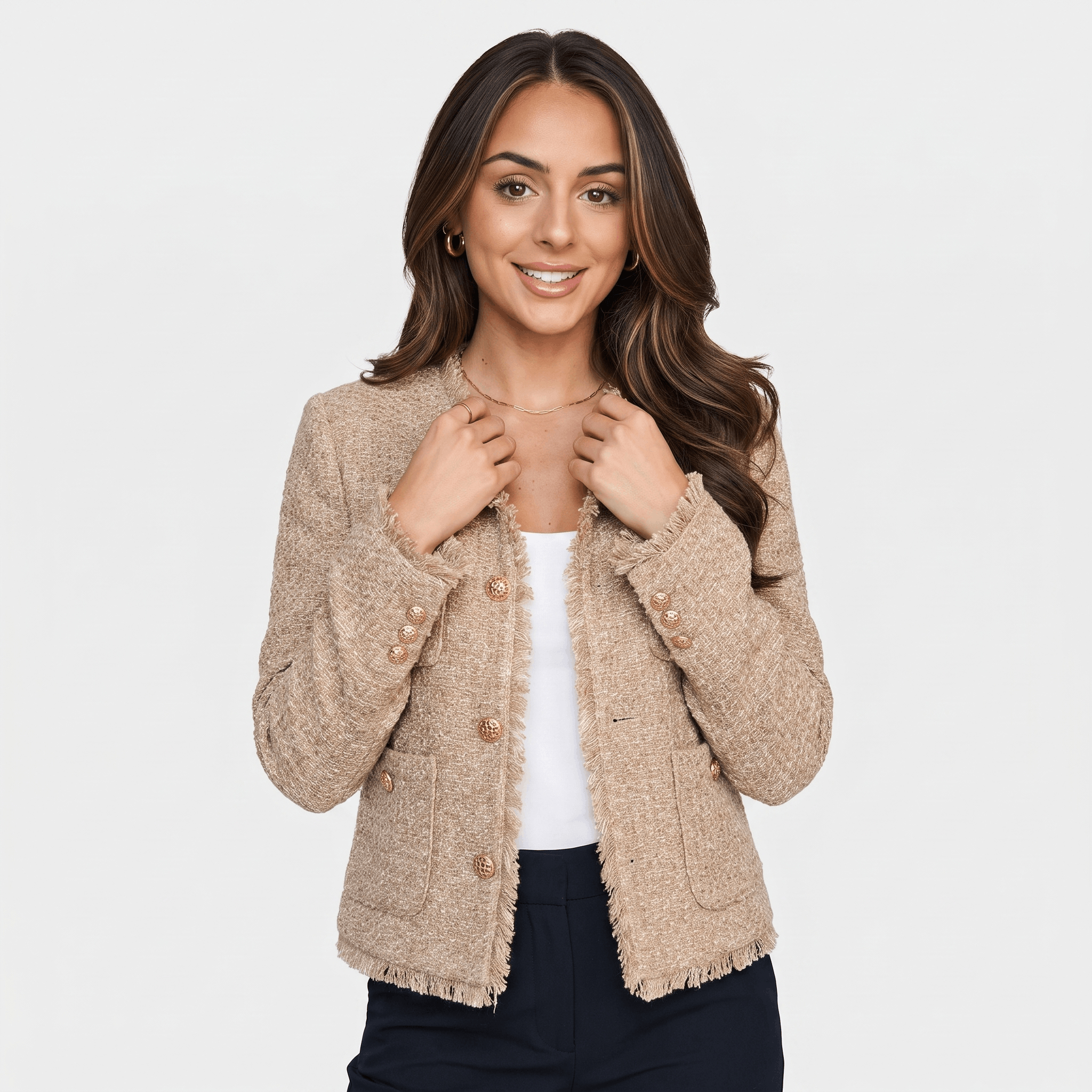 Front view of a woman wearing a beige textured tweed jacket with gold-tone buttons, round neckline, and cropped tailored fit.