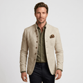 Man wearing a beige textured blazer with a notched lapel, button closure, flap pockets, and pocket square over an olive green shirt and black trousers.