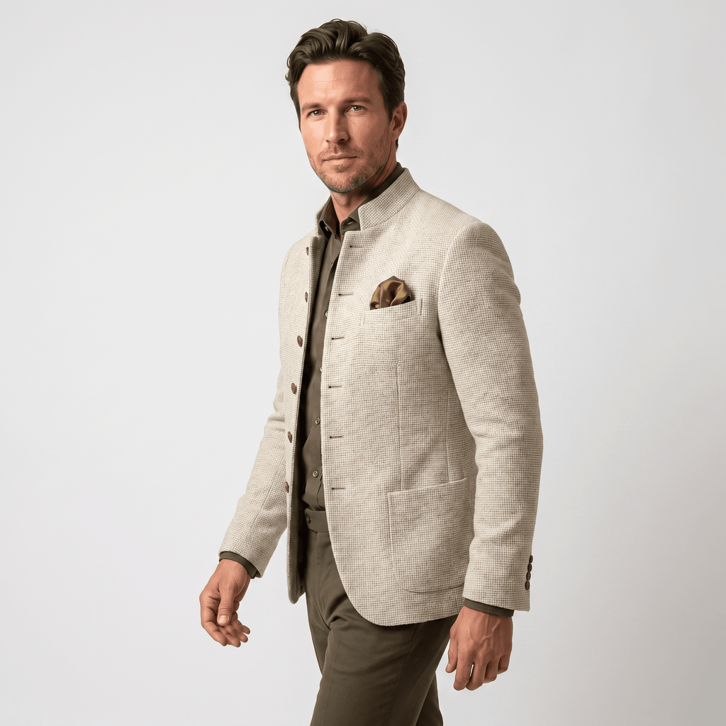 Side view of a man wearing a beige textured blazer with a notched lapel, button closure, flap pockets, and tailored fit.