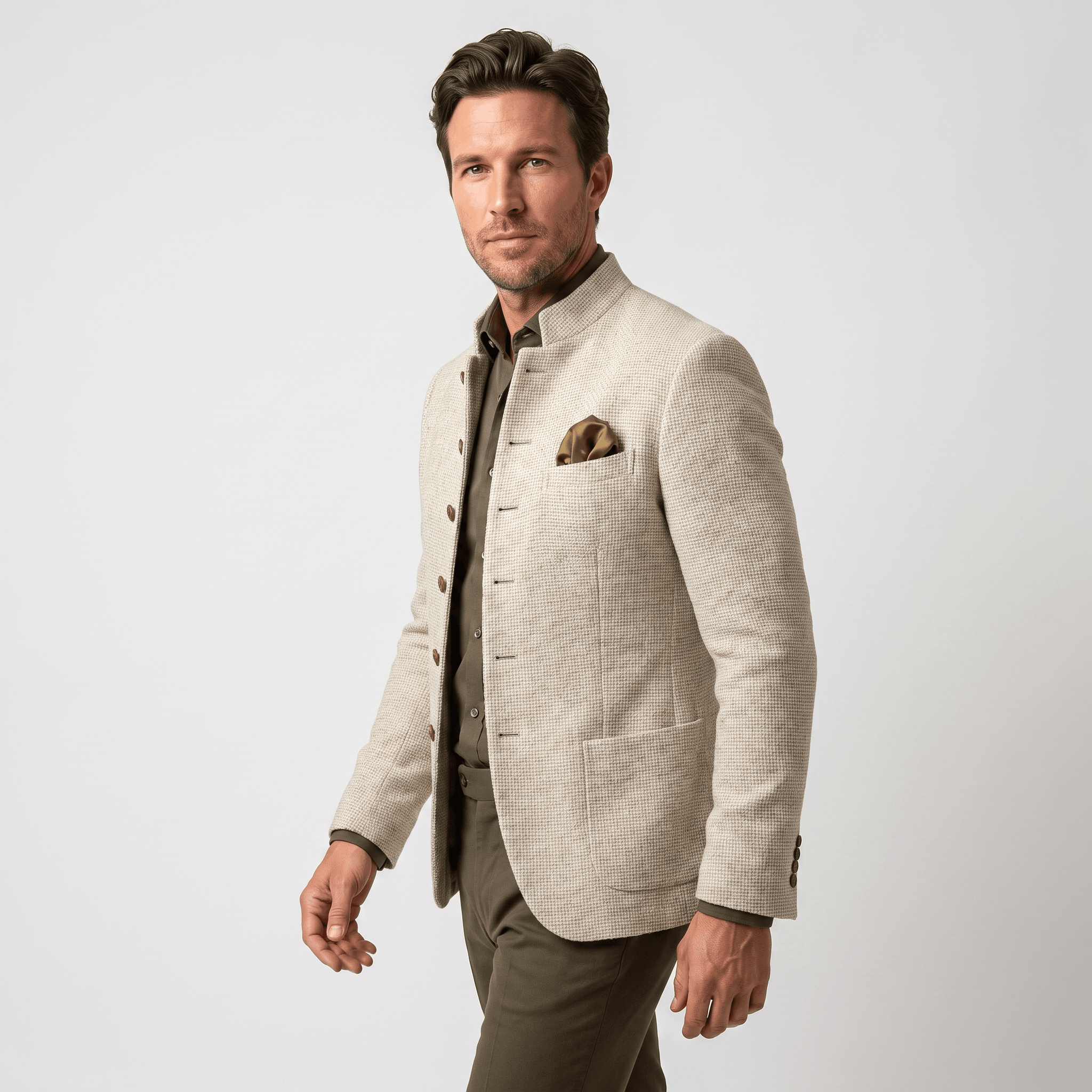 Side view of a man wearing a beige textured blazer with a notched lapel, button closure, flap pockets, and tailored fit.