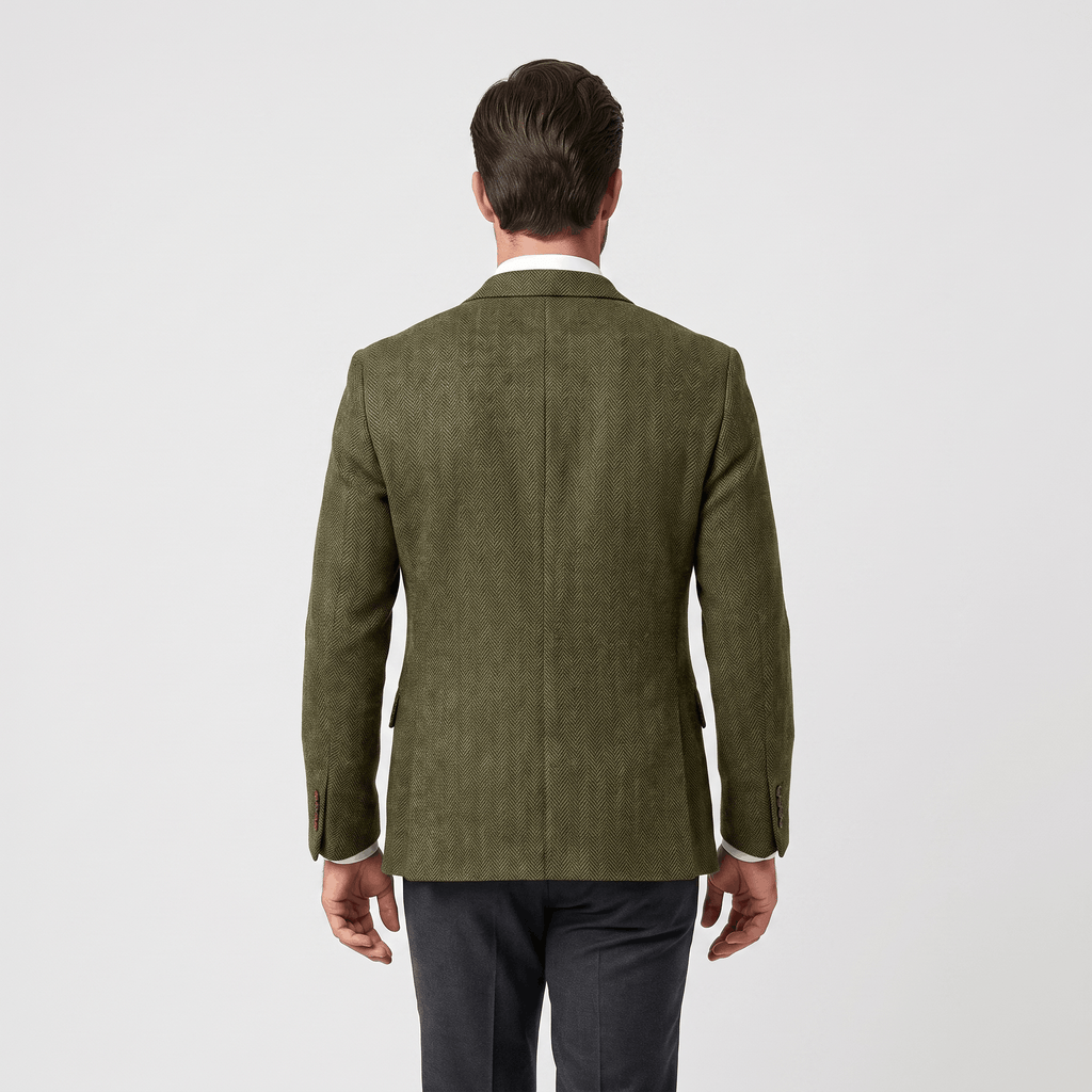 Back view of a man wearing an olive green textured blazer with a tailored silhouette and long sleeves.
