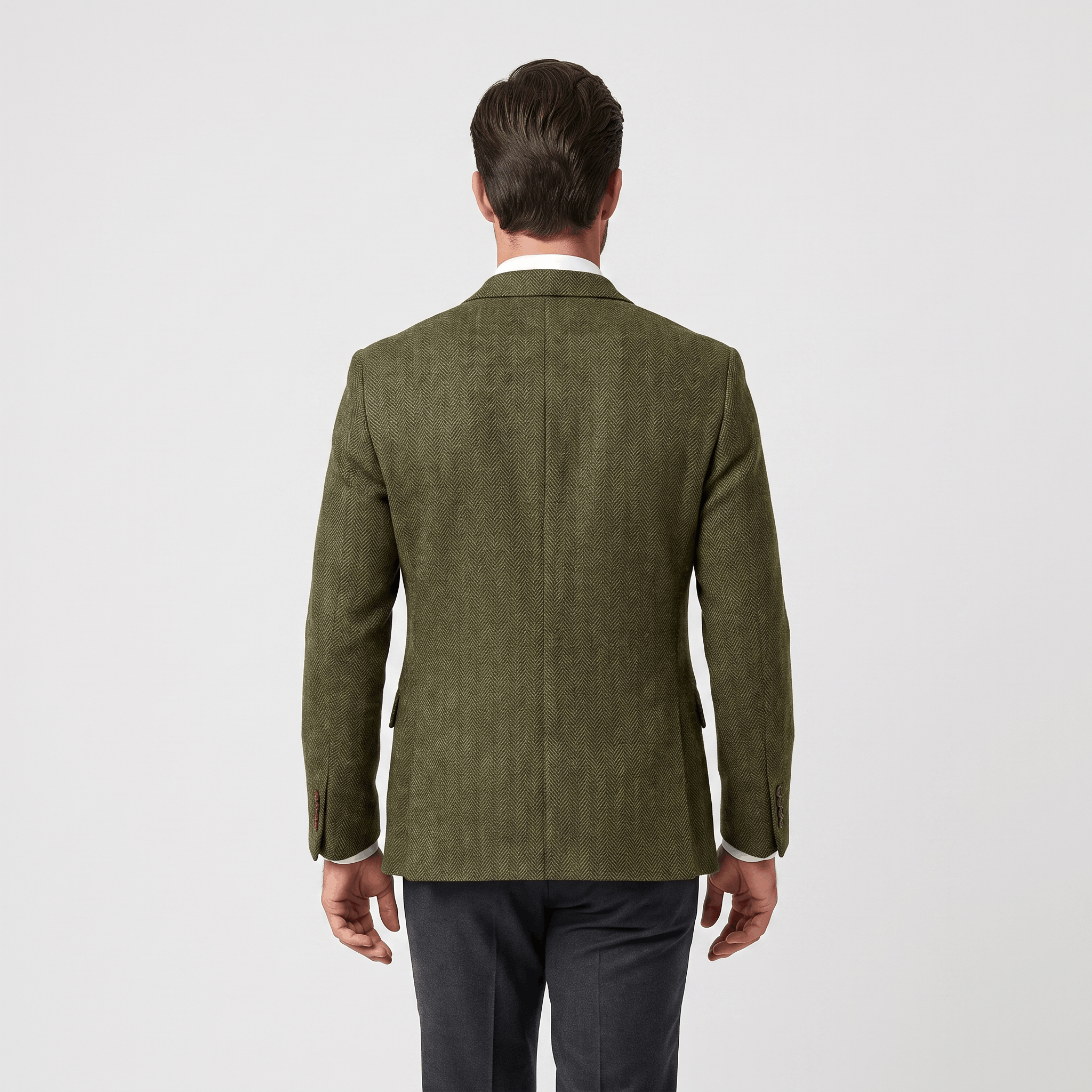 Back view of a man wearing an olive green textured blazer with a tailored silhouette and long sleeves.