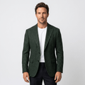 Man wearing a dark green textured blazer with a notched lapel, button closure, flap pockets, and tailored fit over a white crew-neck shirt and black trousers.