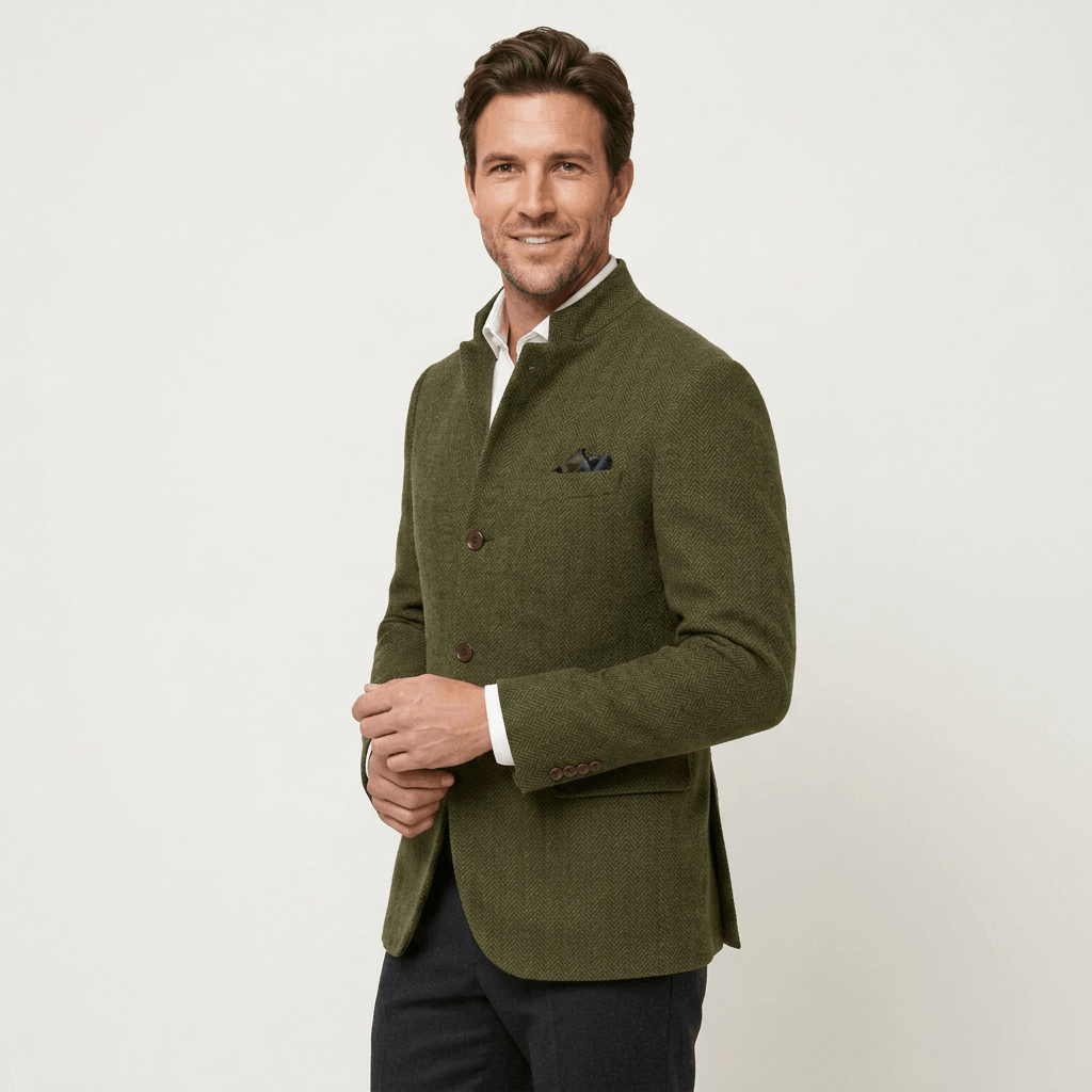 Man wearing an olive green textured blazer with a notched lapel, button closure, flap pockets, and tailored fit over a white dress shirt and black trousers.