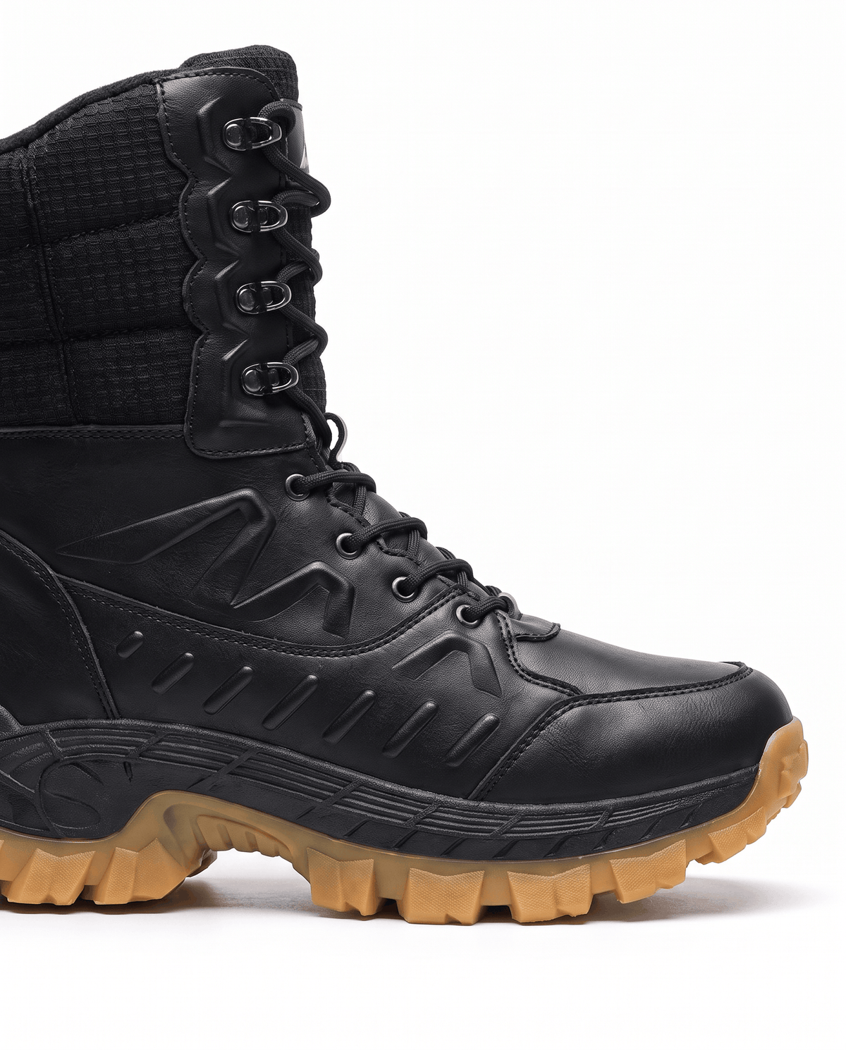 Close view of black quilted boot shaft, laces and thick tan lug sole