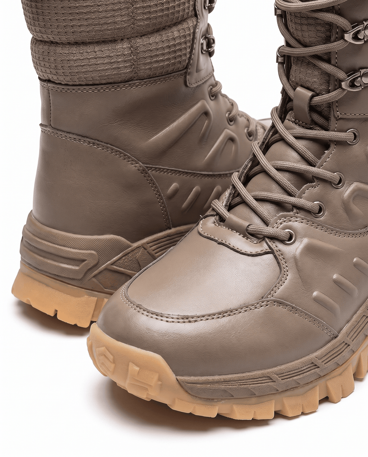 Close view of khaki boot toe with lace-up front and chunky tan outsole