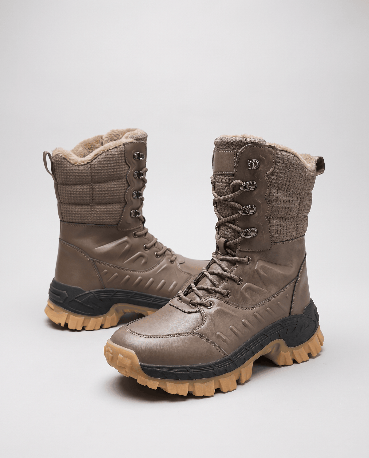 Pair of khaki boots angled to show quilted shafts, soft collar trim and chunky soles