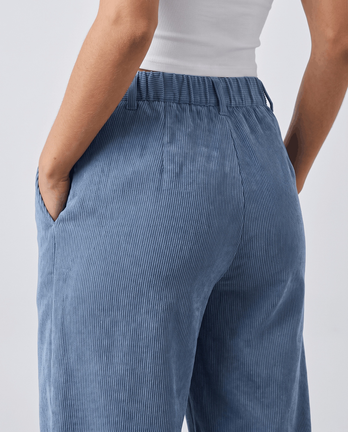 Back close-up of pale blue corduroy showing the elastic back waistband and hip fit