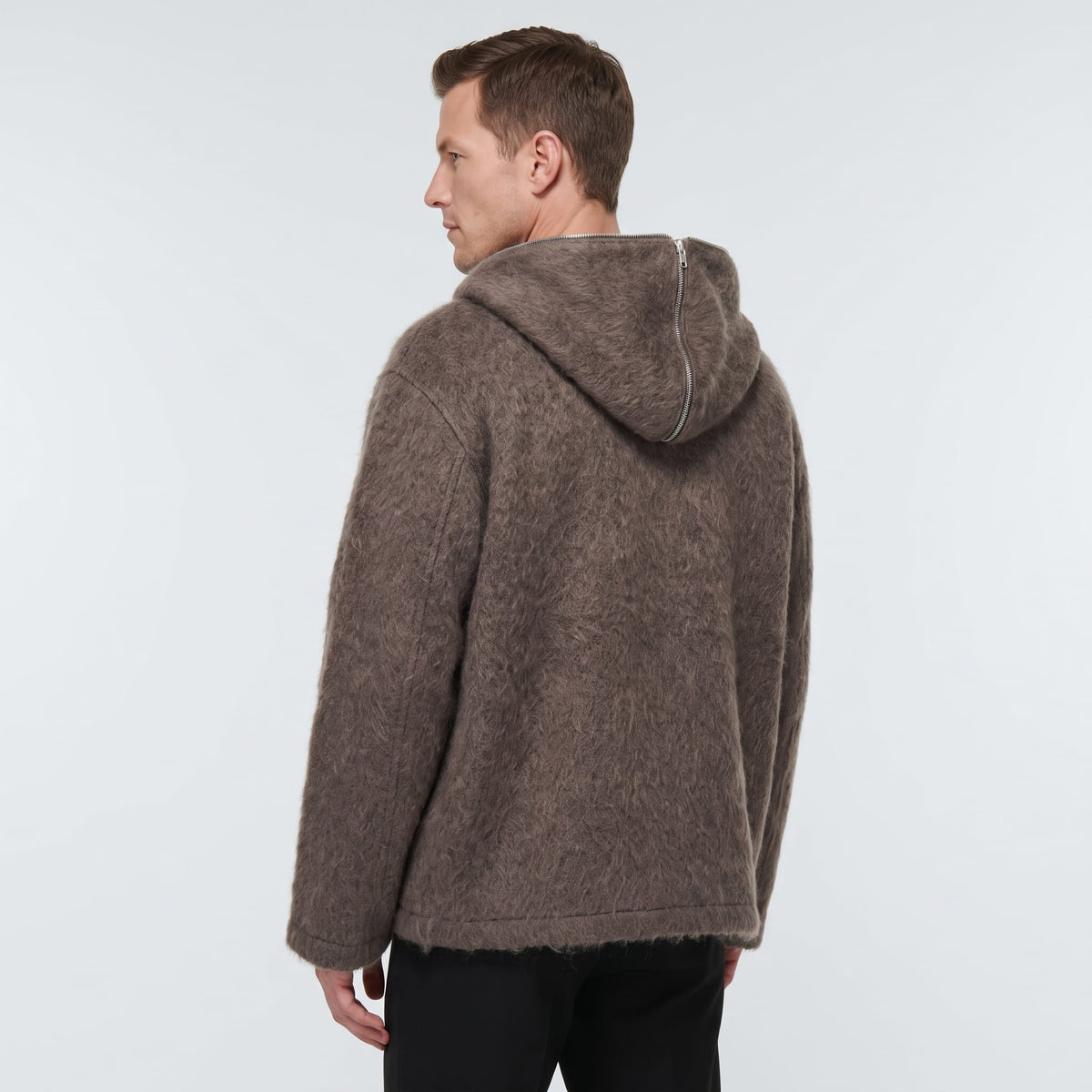 Back view of the brown hooded cardigan with its relaxed hip-length cut