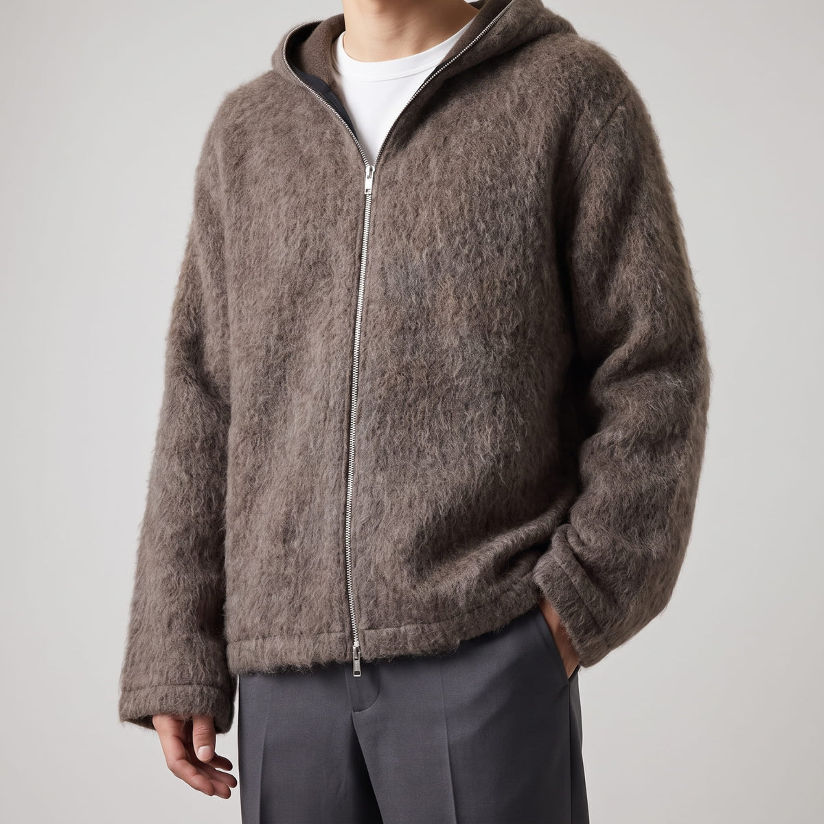 Front view of the brown long-pile knit cardigan zipped over a white tee
