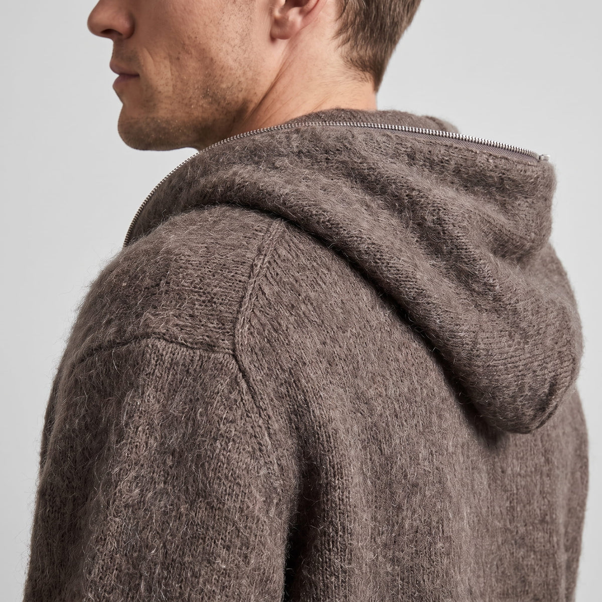 Close-up of the brown cardigan's knit hood and soft brushed texture