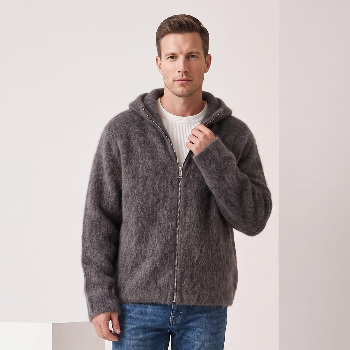 Men's hooded fuzzy zip-up cardigan sweater in gray over a white tee and jeans