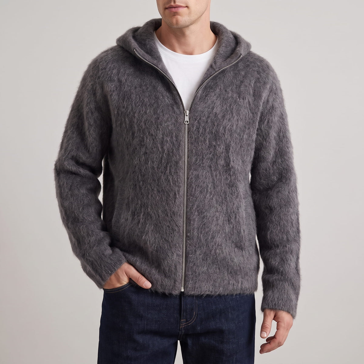 Front view of the gray long-pile knit hooded cardigan zipped over a white tee