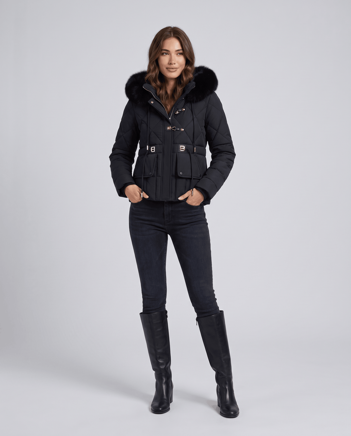Model in black quilted jacket with plush-trim hood, cropped front view