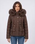 Model in brown quilted jacket with plush-trim hood, front view with arms relaxed
