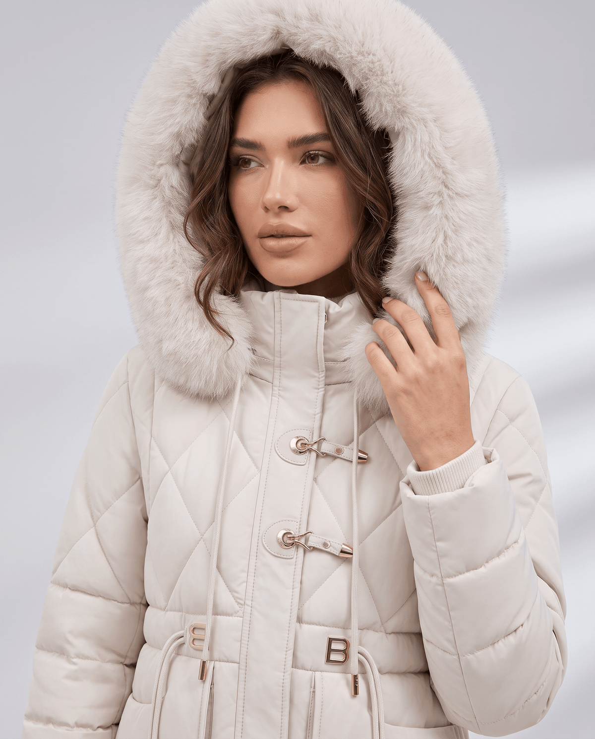 Model in white quilted jacket with plush-trim hood up and metal hook clasps