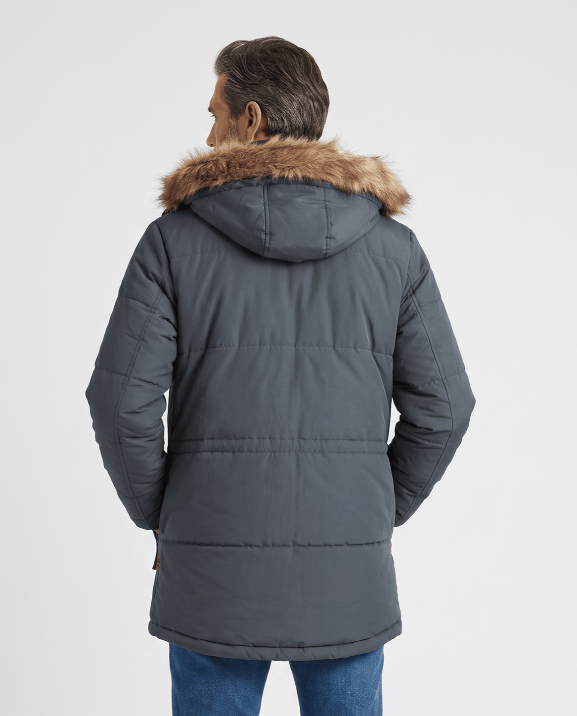 Back view of dark blue parka showing hood with fur trim and padded body