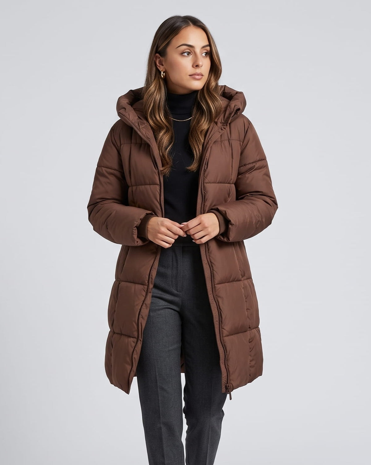 Dark brown coat worn open over a black turtleneck and gray jeans