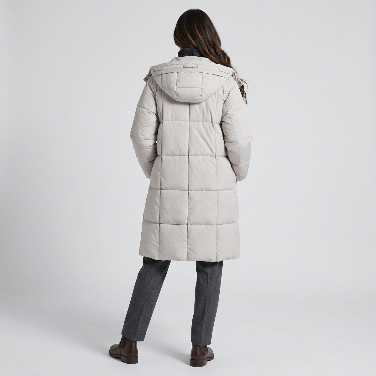 Back view of off-white coat showing the hood and horizontal quilting