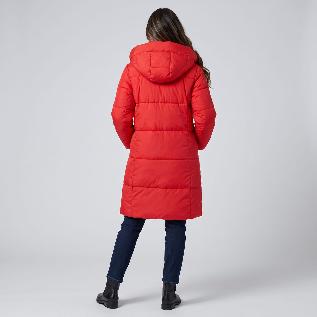 Back view of red coat with the hood down over blue jeans