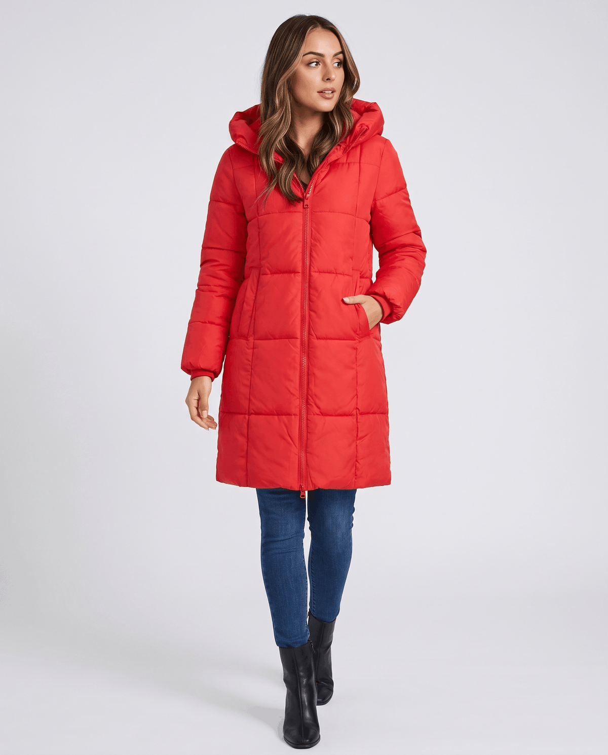 Full-length view of red coat with hands in pockets and black boots