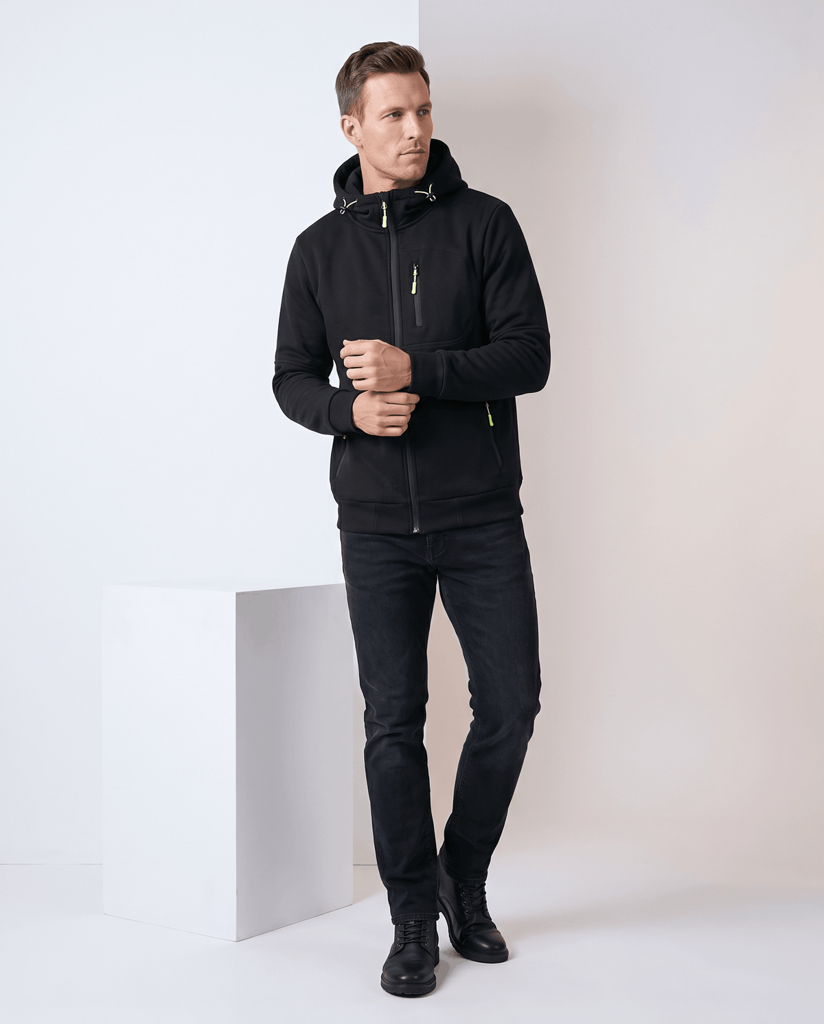 Full-length view of the black hoodie with black jeans and boots