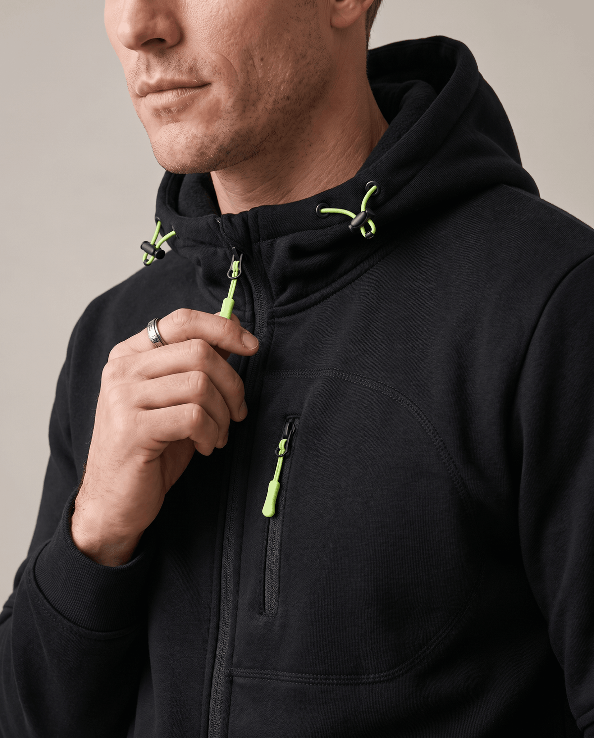 Close-up of the zip and drawstring hood on the black fleece hoodie