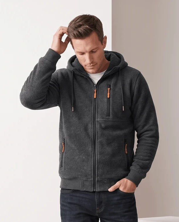Dark gray hoodie with a hand in the hair and one in a pocket