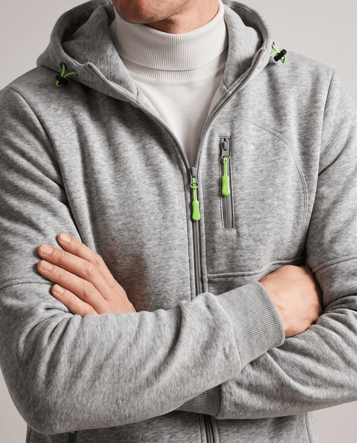 Heather gray hoodie with neon zip pulls worn over a white turtleneck