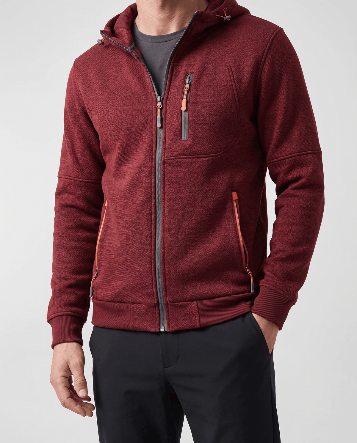 Front view of the red zip-up hoodie over a gray tee with zip pockets