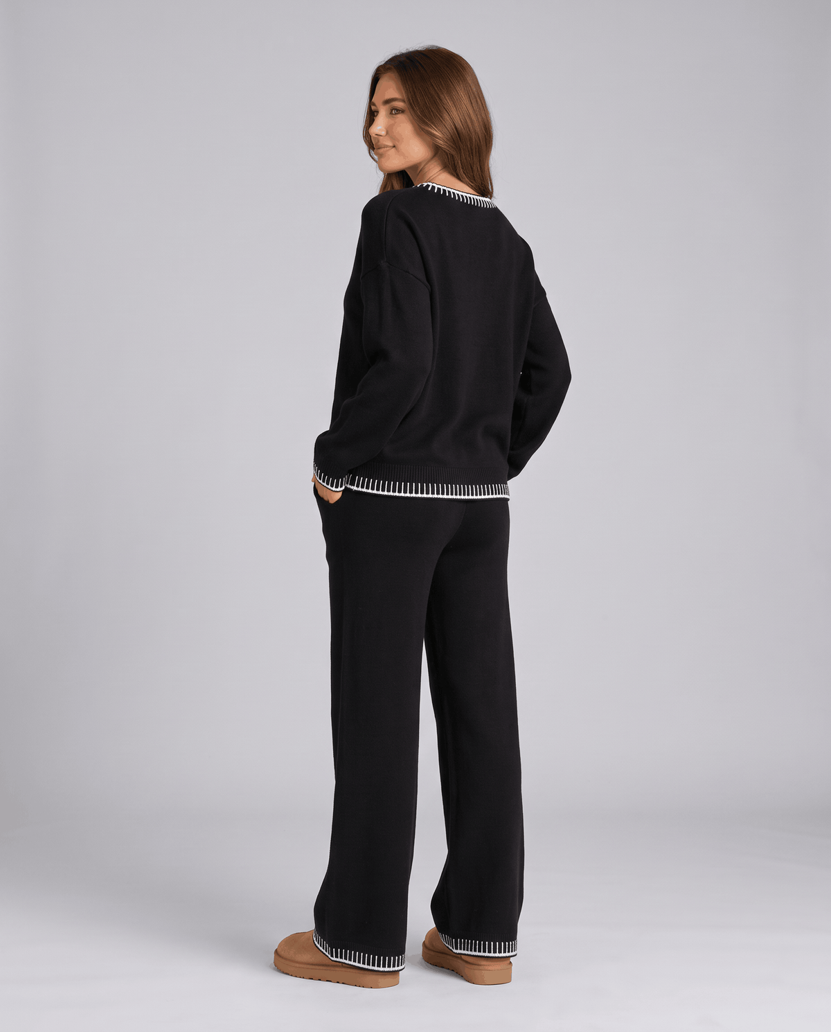 Back view of the black knit sweater and wide-leg pants