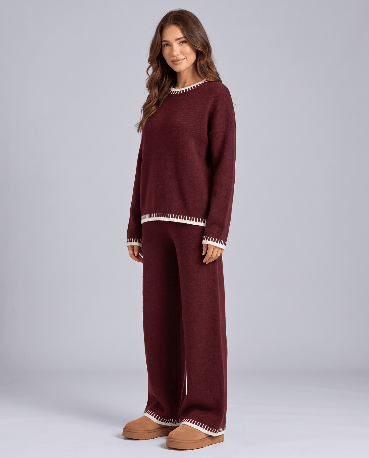 Burgundy knit sweater with light contrast trim and wide-leg pants, front view