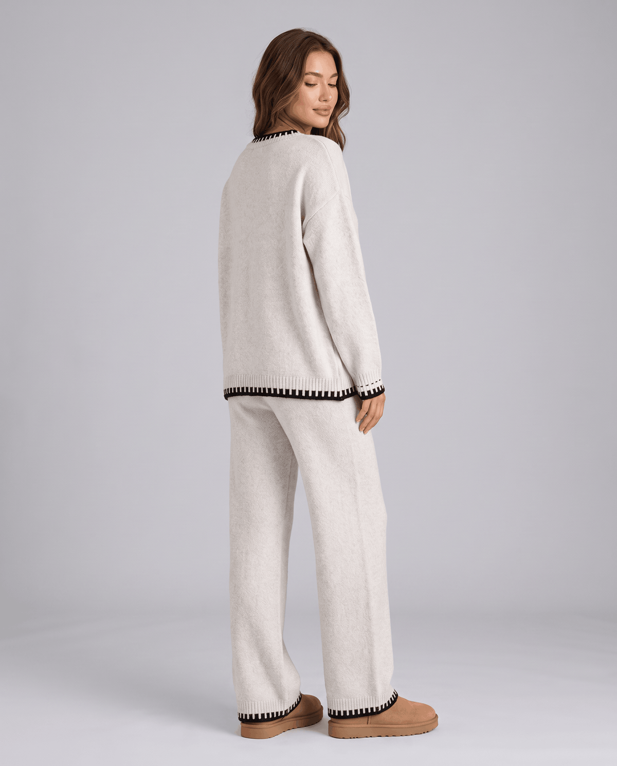 Back view of the cream knit sweater and wide-leg pants