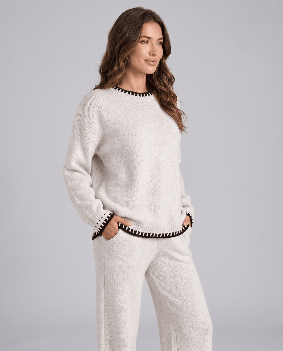 Cream knit sweater with black contrast trim and matching wide-leg pants, front view