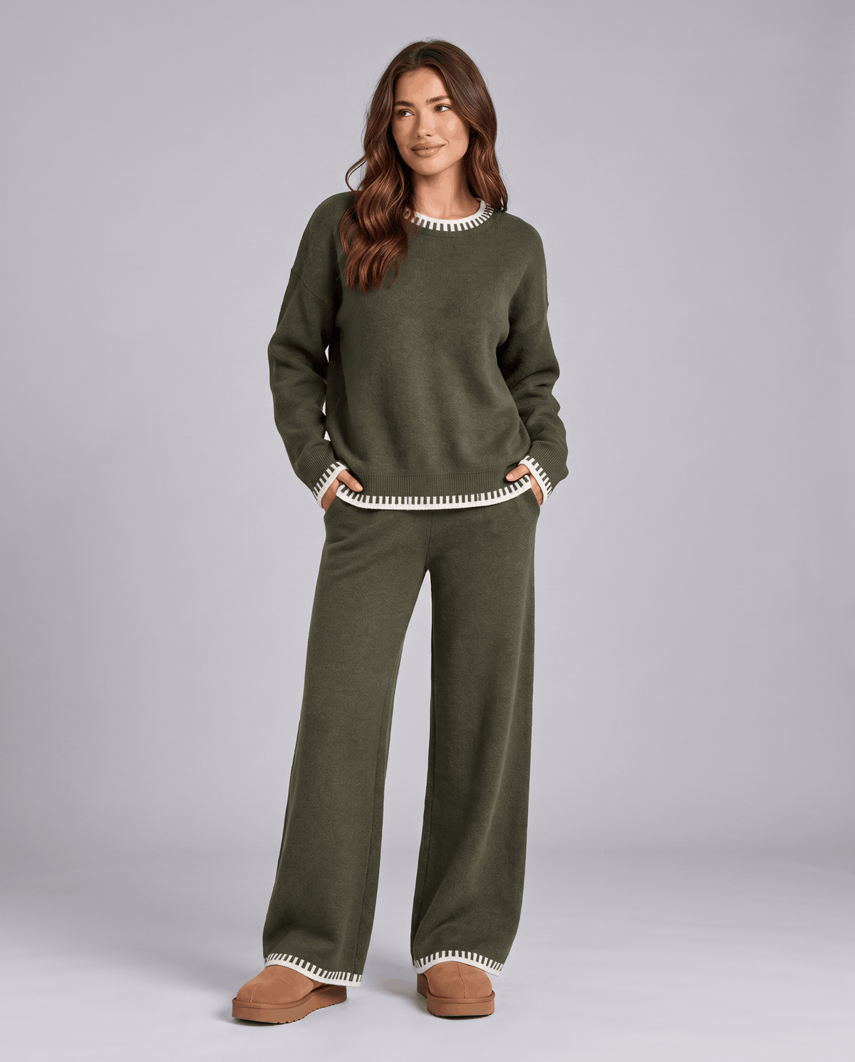 Dark green knit sweater with light contrast trim and wide-leg pants, front view
