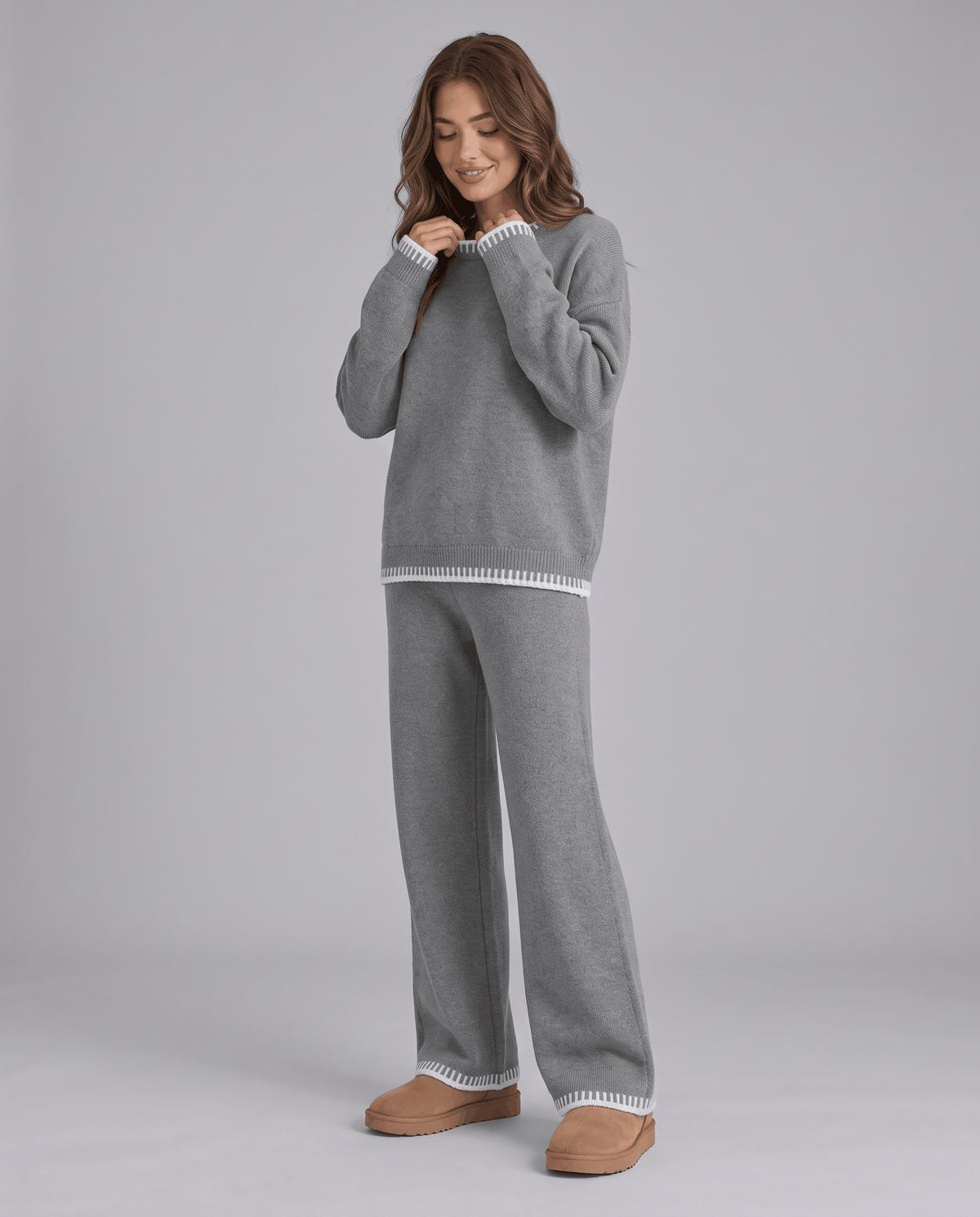 Grey knit sweater with light contrast trim and wide-leg pants, front view