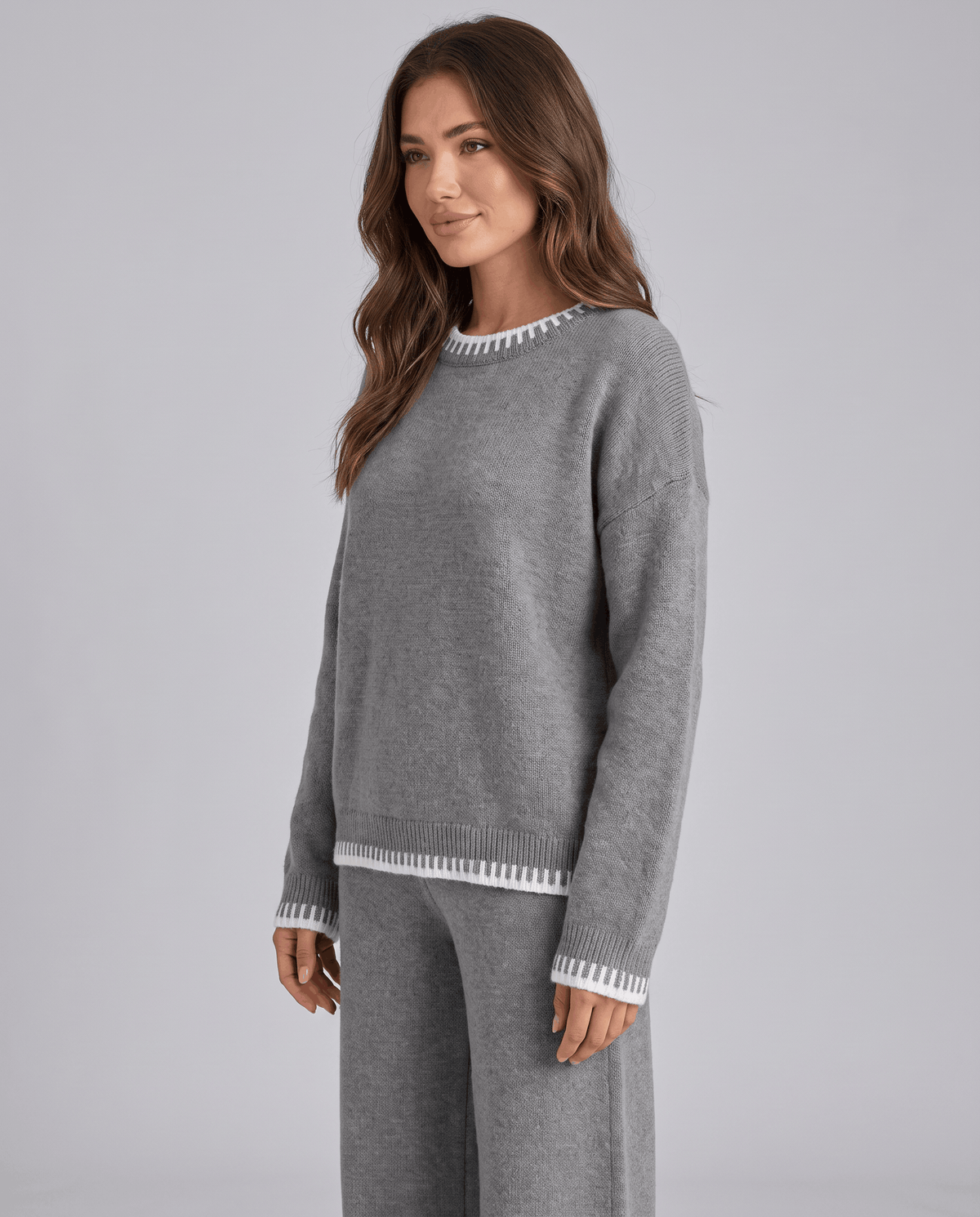 Grey knit sweater with relaxed oversized fit, three-quarter front view