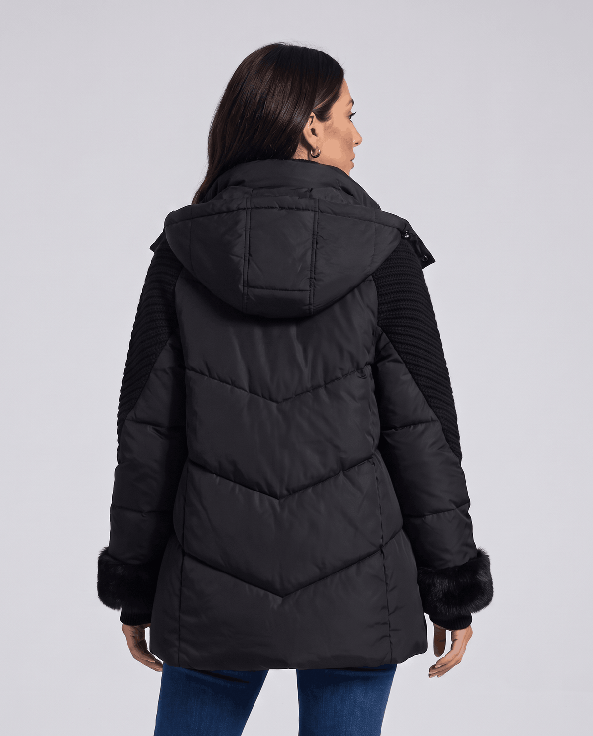 Back view of black jacket with hood and chevron-quilted body