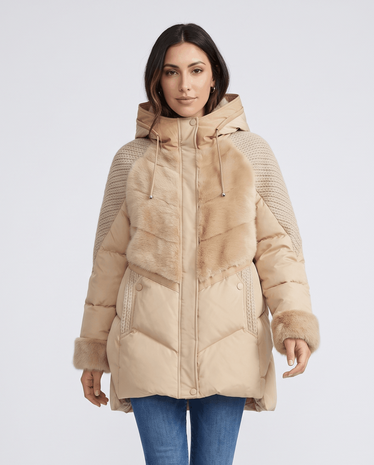 Woman in khaki knit-panel hooded puffer jacket with plush trim and blue jeans